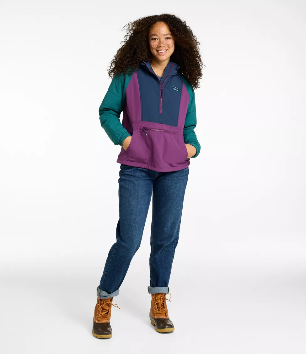 Woman wearing a navy, purple, and teal L.L.Bean anorak with jeans and duck boots.