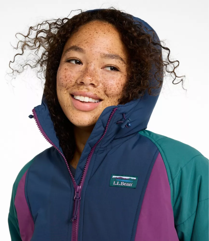 Close-up of a woman's face under the hood of a navy, purple, and teal L.L.Bean anorak.