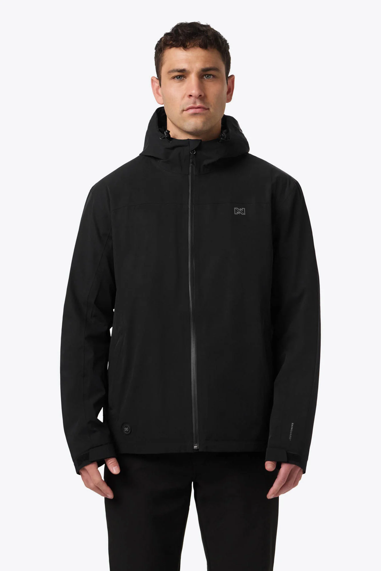Man wearing a black Mobile Warming hooded jacket, front view.