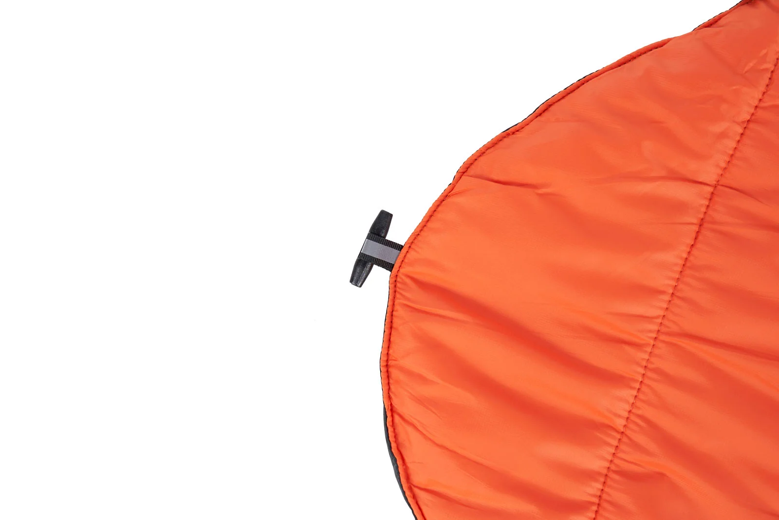 Close-up of the rounded corner of an orange quilted dog blanket with a black toggle.
